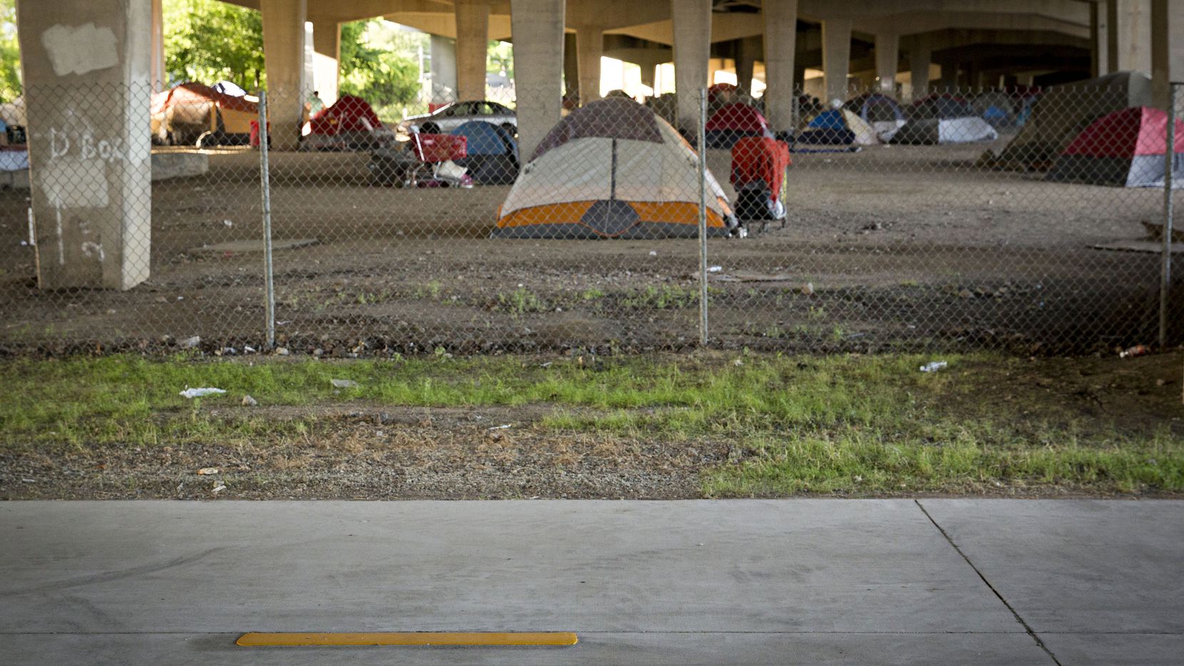 A photograph of a homeless encampment near Fair Park in Dallas, TX